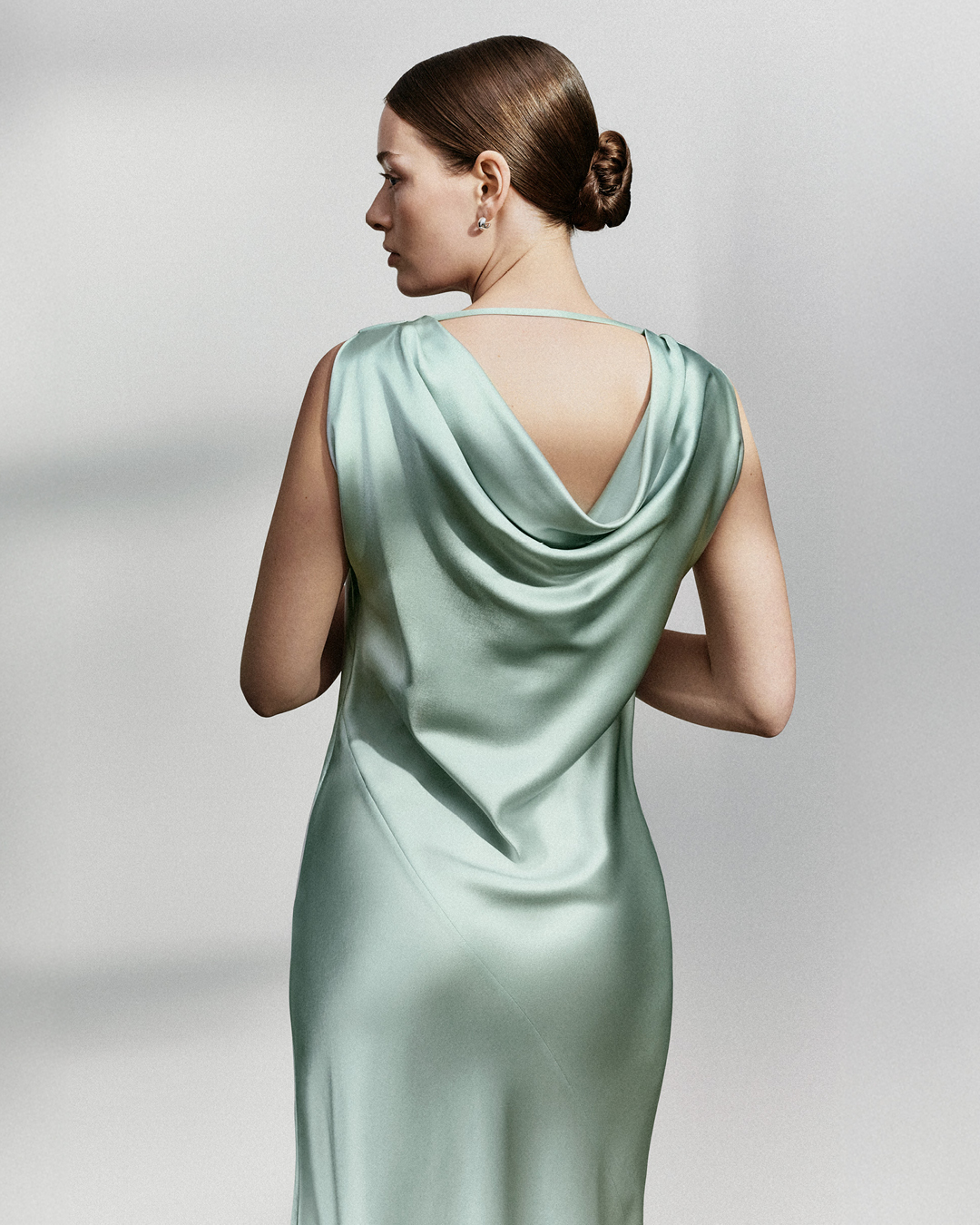 Woman in light green satin dress